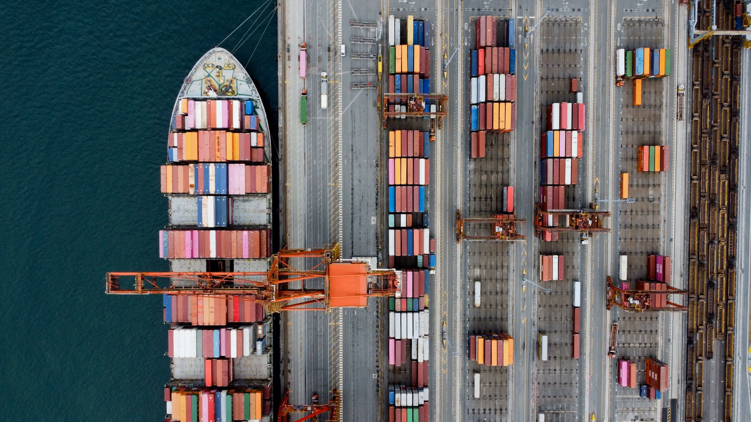 Stack of green metal barrels arranged horizontally with visible bolts on top.
